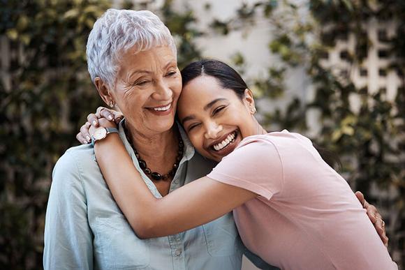 Younger woman hugging mother